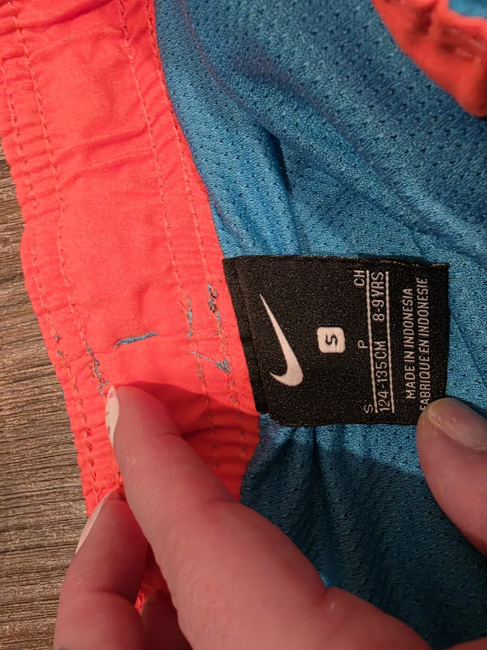 Nike Kids Blue Swim Trunks with Orange Accents